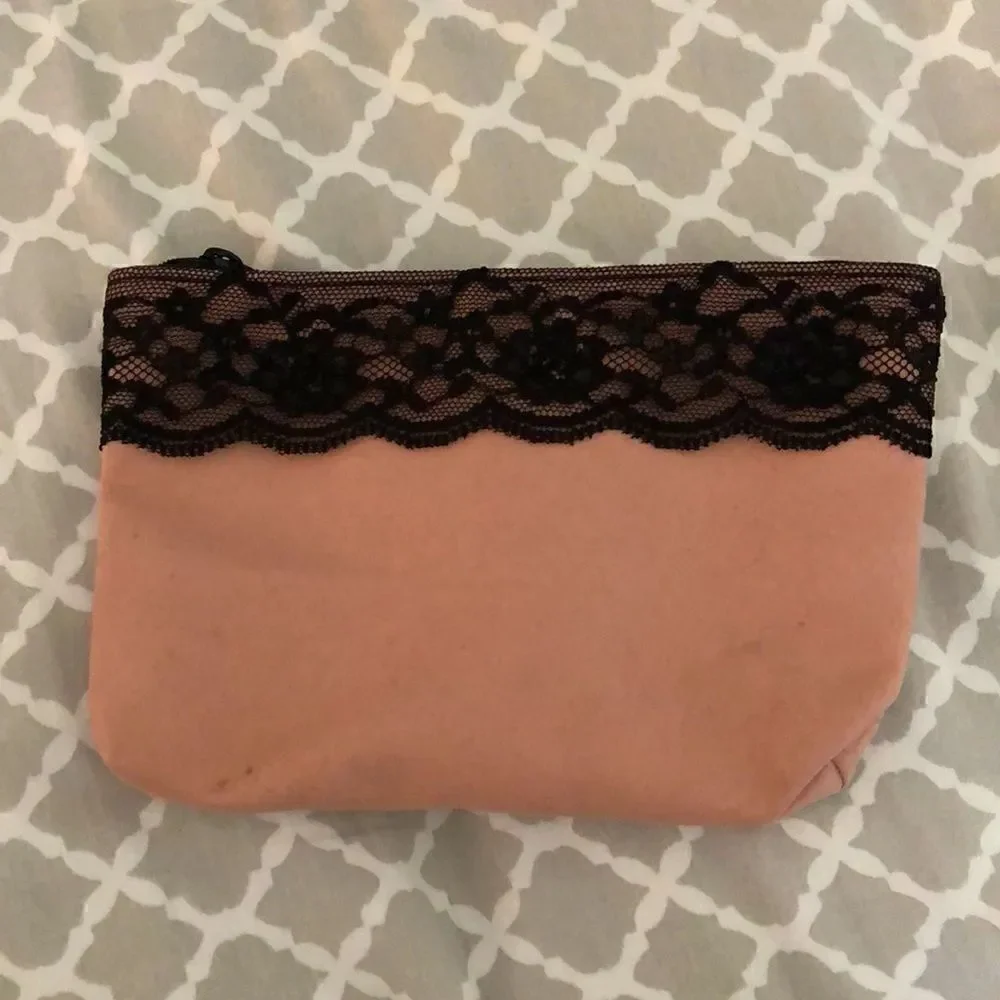 IPSY pink cosmetics bag with black lace trim, includes 5 trial products